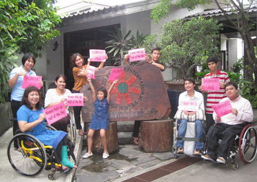 Staffs at  DPIAP office signs are fo  women equality campaign. Saowalak Thongkuay is seated at left.